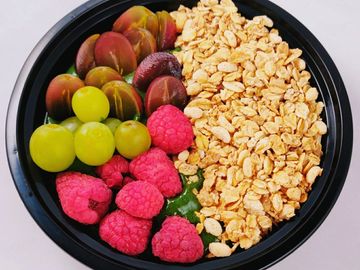 Oatmeal with berries on the side with grapes 