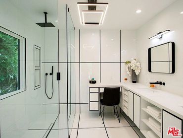 Modern bathroom remodel with large format tile and custom cabinets. ADA shower 