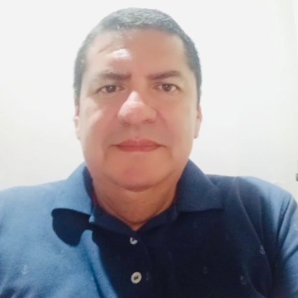 Man in a blue polo shirt facing the camera.