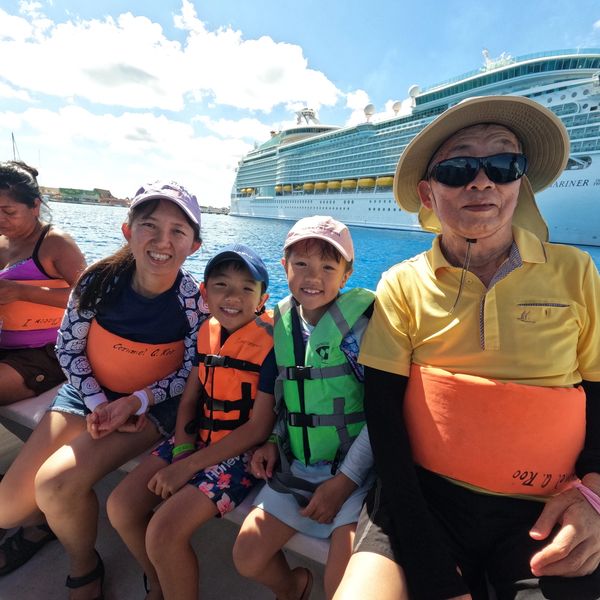 A family on a boat for a snorkel trip with Cozumel Anglers.