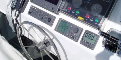 Boat steering wheel and control panel.