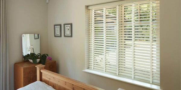 faux wood blinds with fabric ribbons or tape in a bedroom