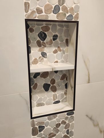 A custom river rock niche in a tile shower in Myrtle Beach, South Carolina