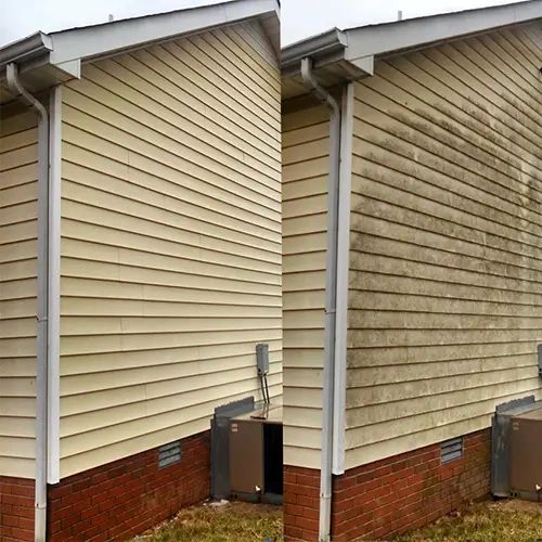 Professional pressure washing service in Clarksville TN - Team member is house washing the siding