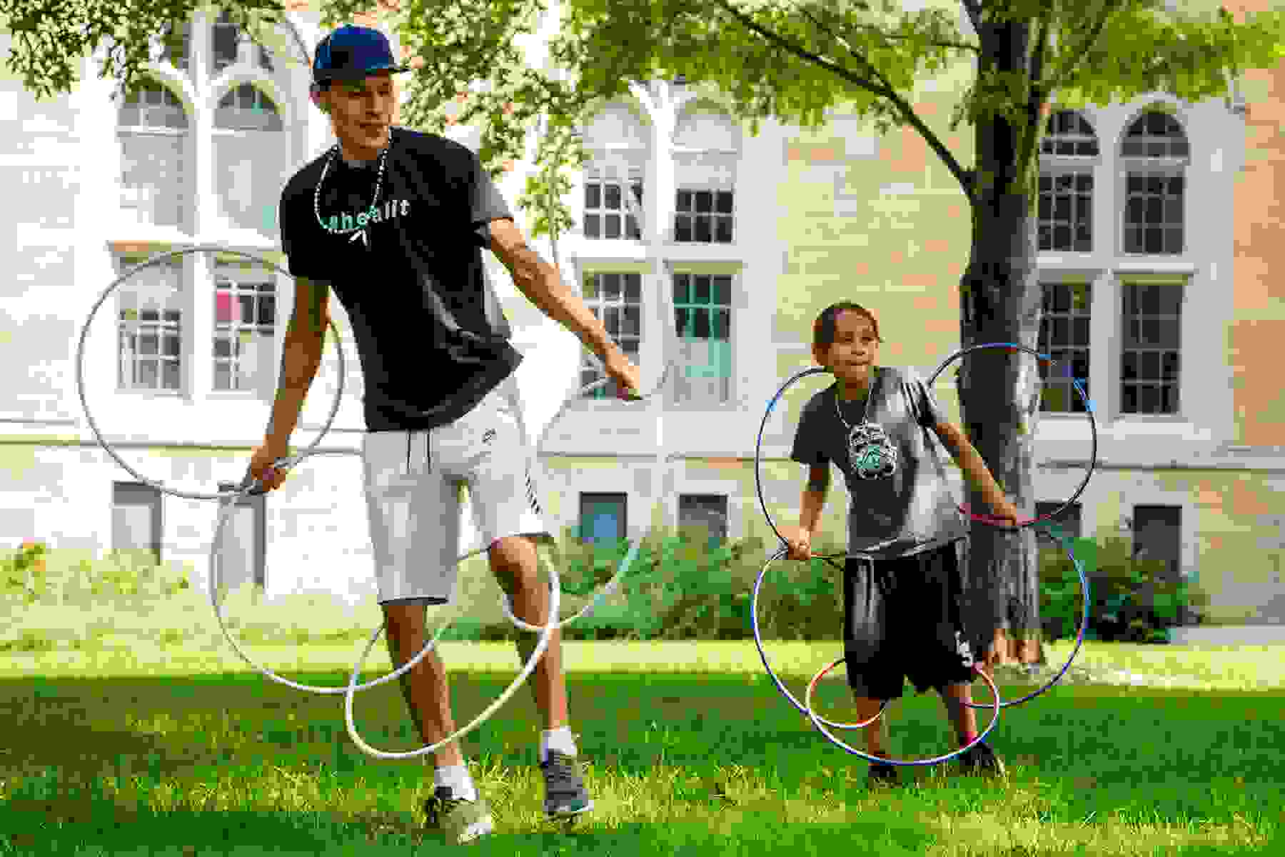 Lumhe and son, Locv, practicing hoop dance.