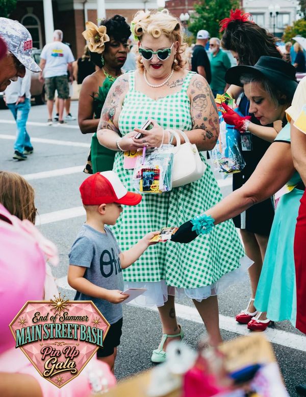 Festive moment at Main Street Bash Pin Up Gala with child and adults.