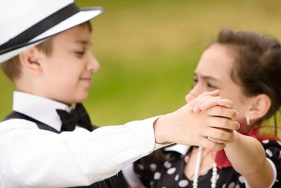 A two children dancing On the garden