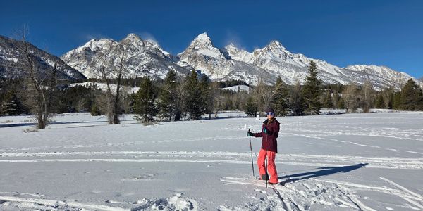 A geologist stands in front of the Teton Range near Jackson, Wyoming.