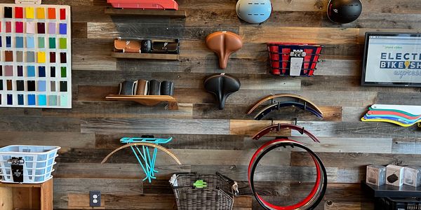 Wall display of various bicycle accessories and parts in a shop.