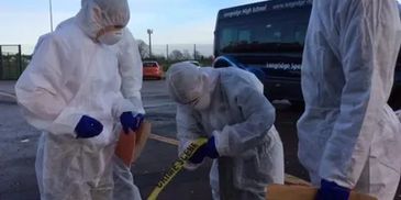 People in hazmat suits handling a crime scene investigation.