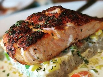 Blackened fish over creamy grits