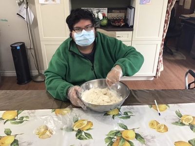 A client mixing a bowl of cookie dough.