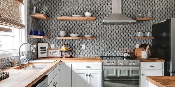 Modern kitchen with wooden countertops and hexagonal tile backsplash.