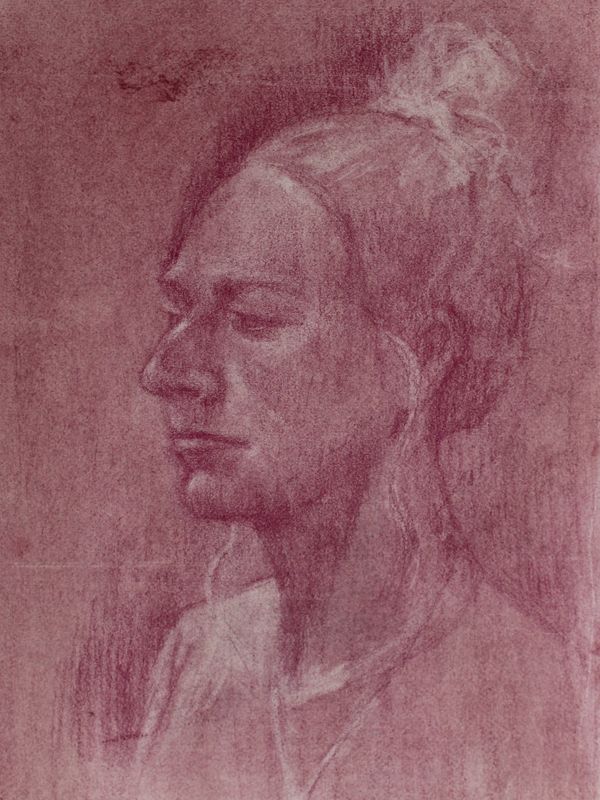 Side profile sketch of a person with hair tied up.