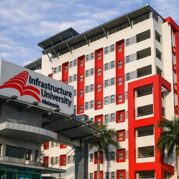 Modern university building in Malaysia with red and white exterior.