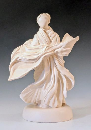 White sculpture of a flowing, abstract figure in robes.
