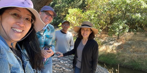 Photo of four local artists: Wei-ting, Jennifer, Tuan, and May, alongside Alamo Creek in Dublin, CA.