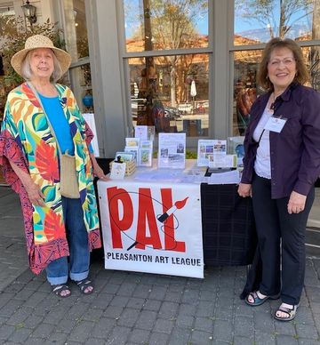 Pleasanton Art League volunteers Lorraine and Emelie helping to recruit more members, just outside t