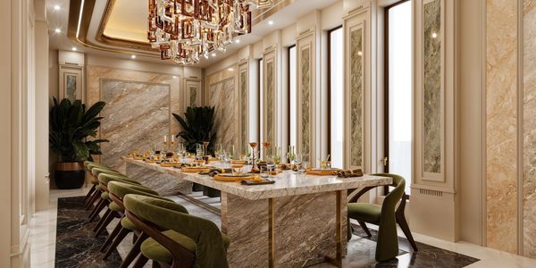 Luxurious dining room with marble table and green velvet chairs.