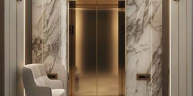 Elegant elevator with gold doors and marble walls in a modern lobby.
