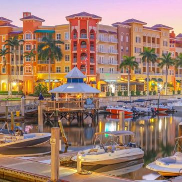 Colorful waterfront buildings and boats at sunset.