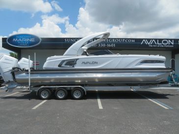 Sleek Avalon pontoon boat parked on a trailer.