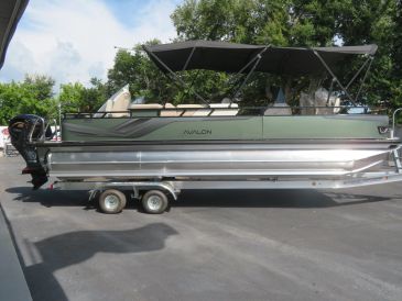Pontoon boat on a trailer under a canopy.
