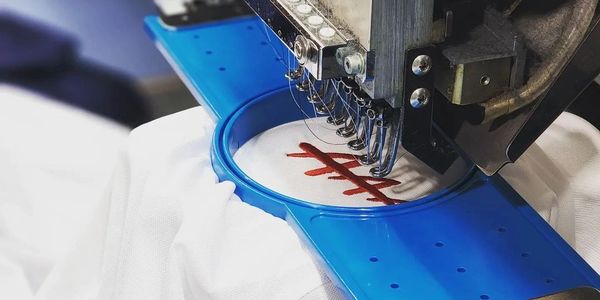 Corporate embroidery machine stitching a logo