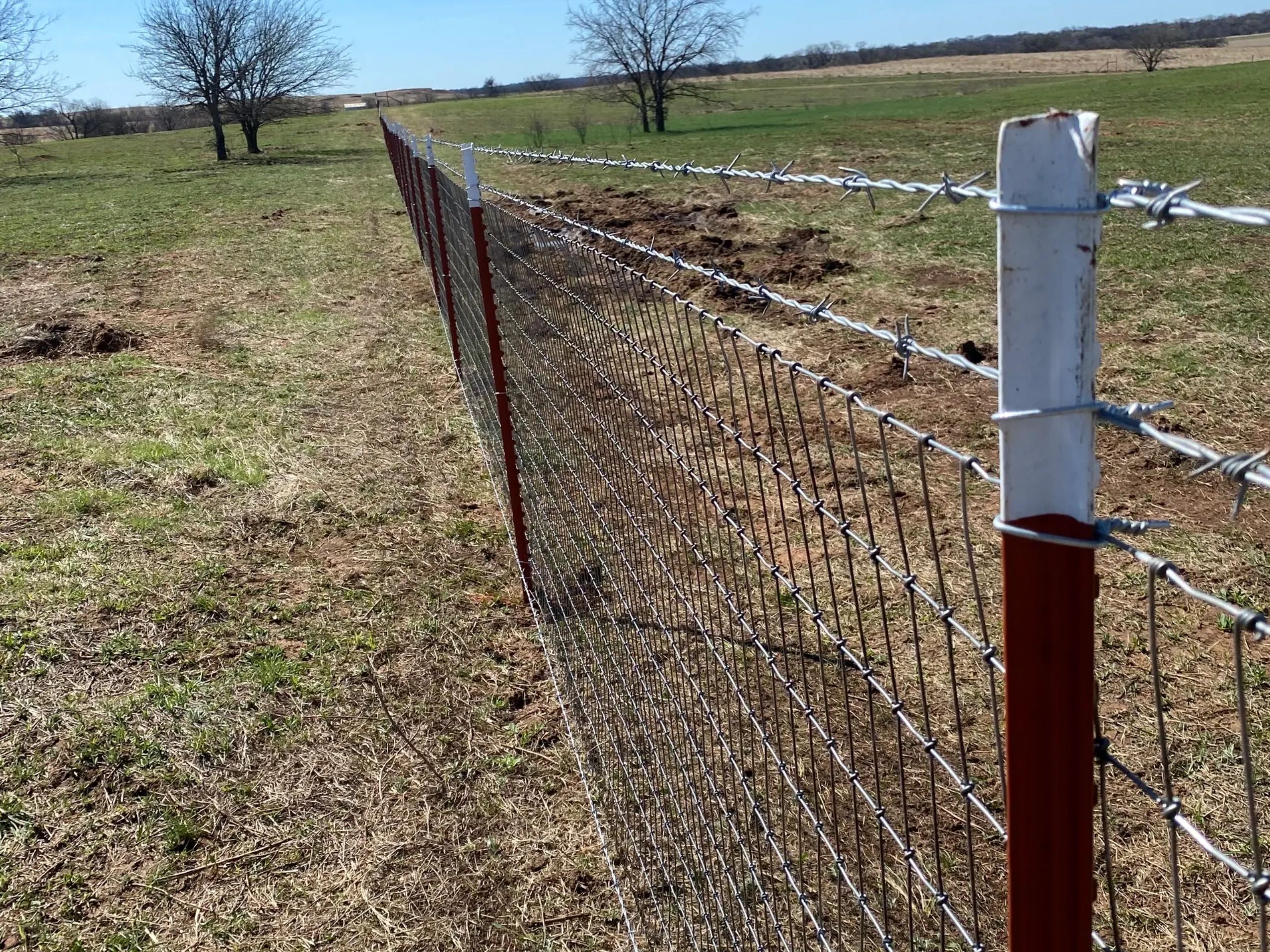 Tpost Fence.

6' tpost and 2"x4" high tensile no-climb with 2 strands of 12.5 ga. 4pt barbed wire.
