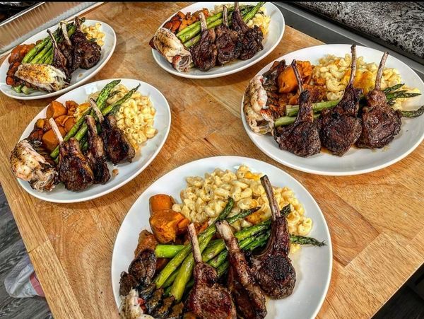 Glazed lamb chops, lobster tails, truffle mac & cheese, asparagus and candied yams.