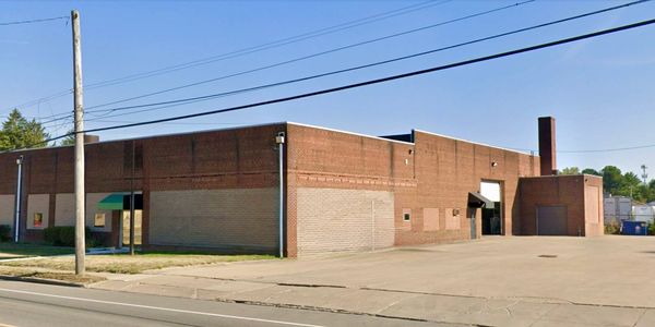 Large brick industrial building on a clear day.