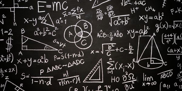 Blackboard filled with mathematical formulas and diagrams.