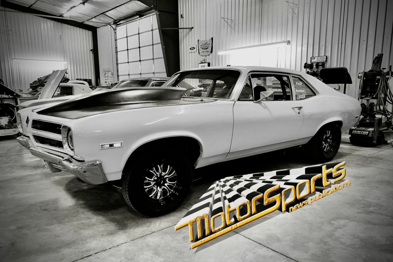 Classic white muscle car in a garage.