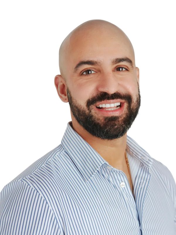 Smiling bald man with beard in a striped shirt.