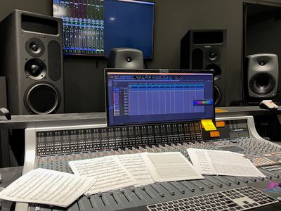 Music studio mixing console with sheet music.