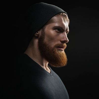 Red headed bearded man’s profile face picture with a clean kept beard using Beard Balm