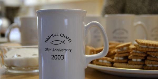 Personalised mug in front of some filled biscuits