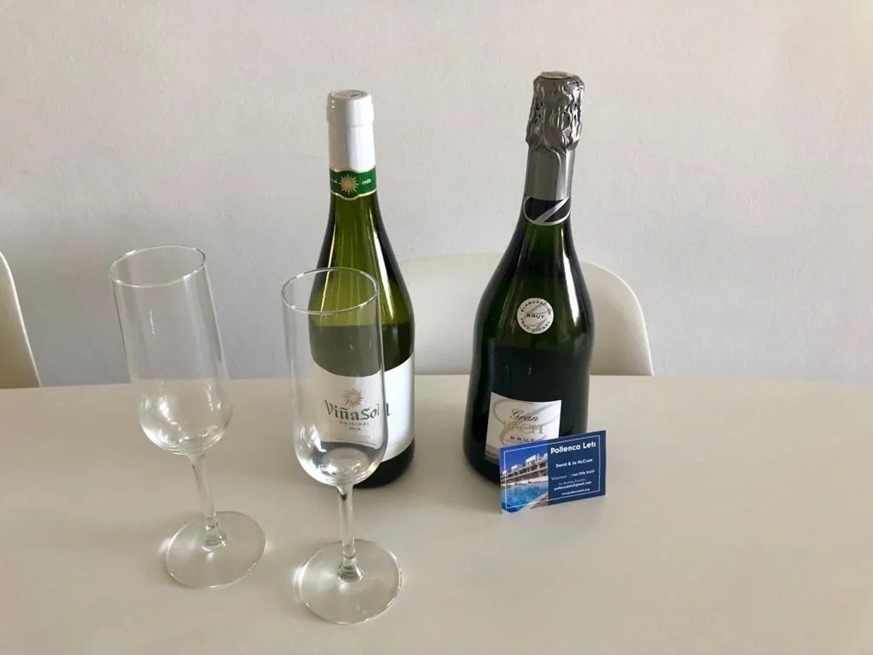 two glasses near 2 champagne bottles