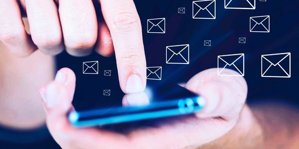 Person pressing their finger onto a smart phone screen, sending an email.