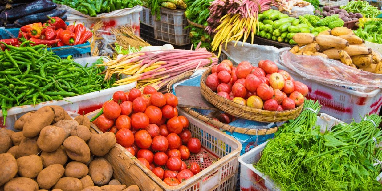 A vibrant market stall filled with fresh vegetables and fruits.