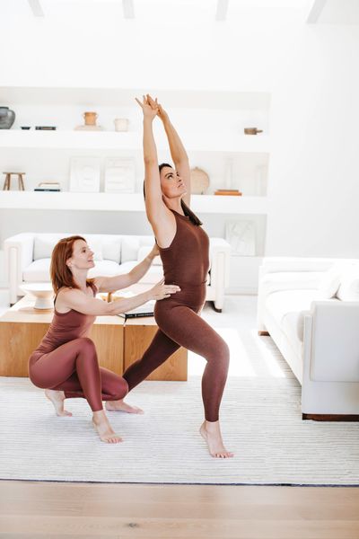 The Fertility Class instructor guiding a student through a standing movement sequence