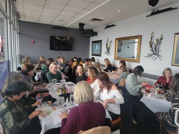 Group of people engaged in a meeting or workshop in a restaurant setting.