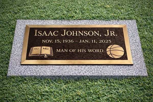 Gravestone plaque of Isaac Johnson, Jr., with dates and symbols.