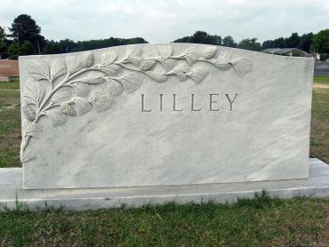 Marble gravestone with the name "LILLEY" and floral carving.