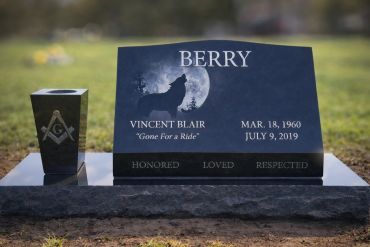Gravestone with motorcycle and memorial details.