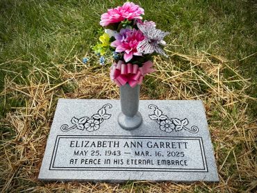 Gravestone of Elizabeth Ann Garrett with flowers.