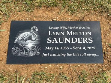 Gravestone for Lynn Melton Saunders with a flamingo engraving.
