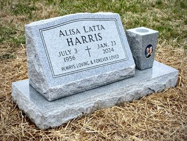 Gravestone for Alisa Latta Harris in a grassy area.