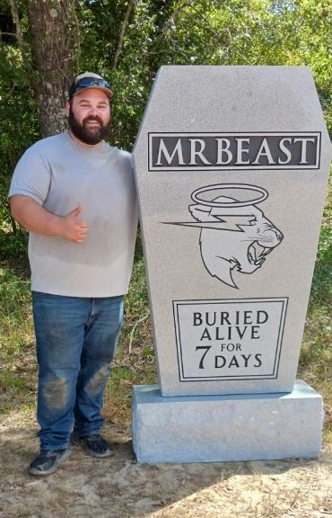 Man giving thumbs up beside MrBeast tombstone with text 'Buried Alive for 7 Days'.