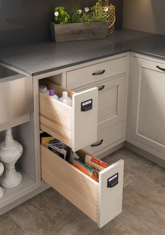 Two pull-out kitchen drawers storing bottles and food packets.